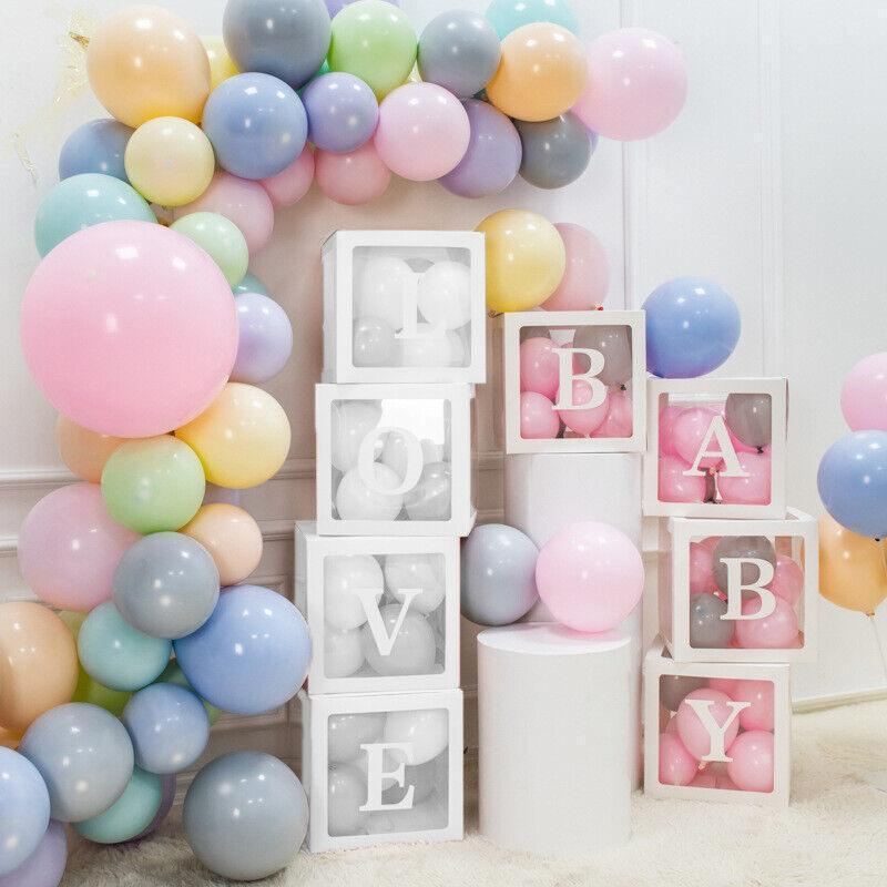 Clear balloon boxes filled with colorful balloons for party decor