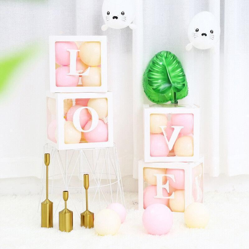 Clear balloon boxes filled with colorful balloons for party decor