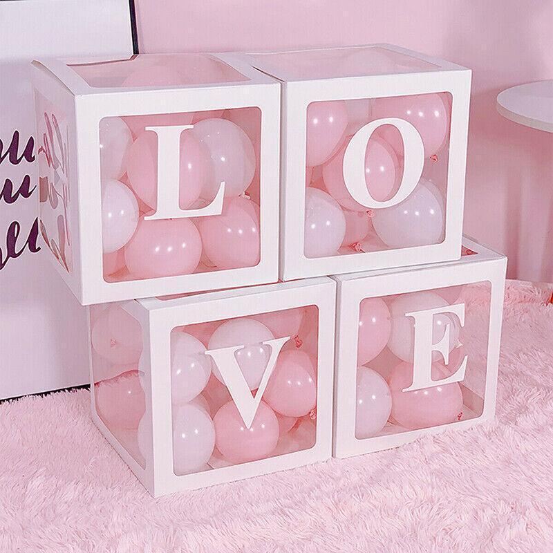 Clear balloon boxes filled with colorful balloons for party decor