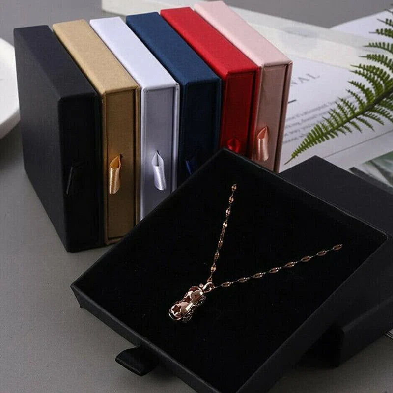 Elegant Jewelry Box Case open on a dresser with various jewelry compartments