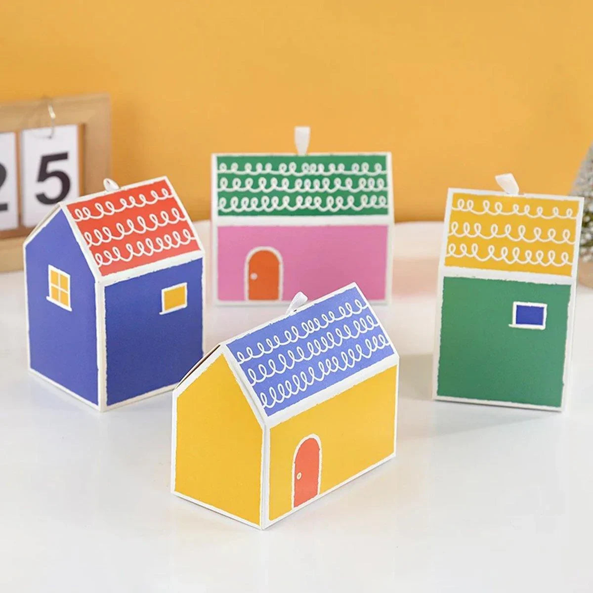 Add a touch of whimsy and colour to your next event with these charming small house gift boxes.