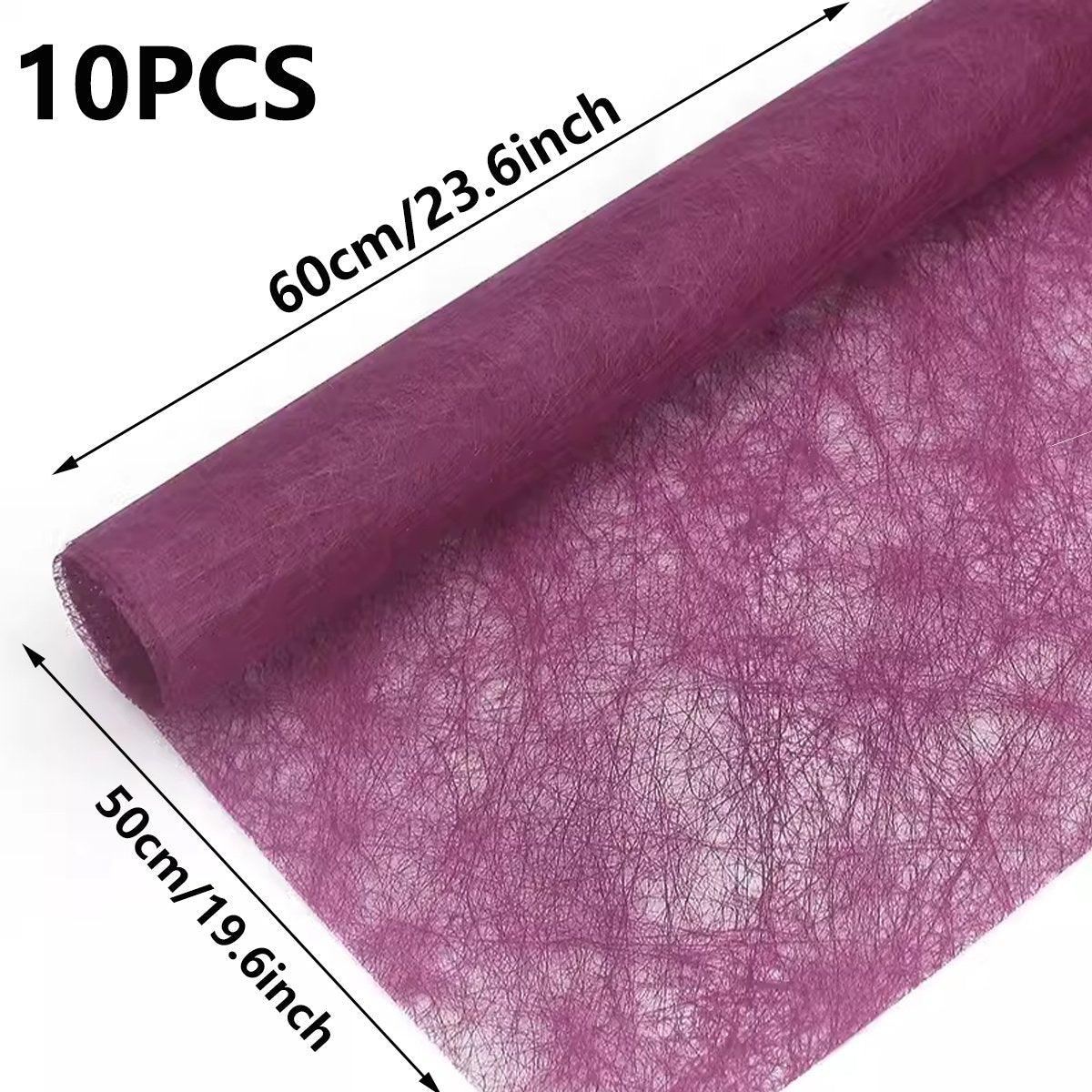 A selection of fabric sheets in various colors, including pink, white, brown, and blue.