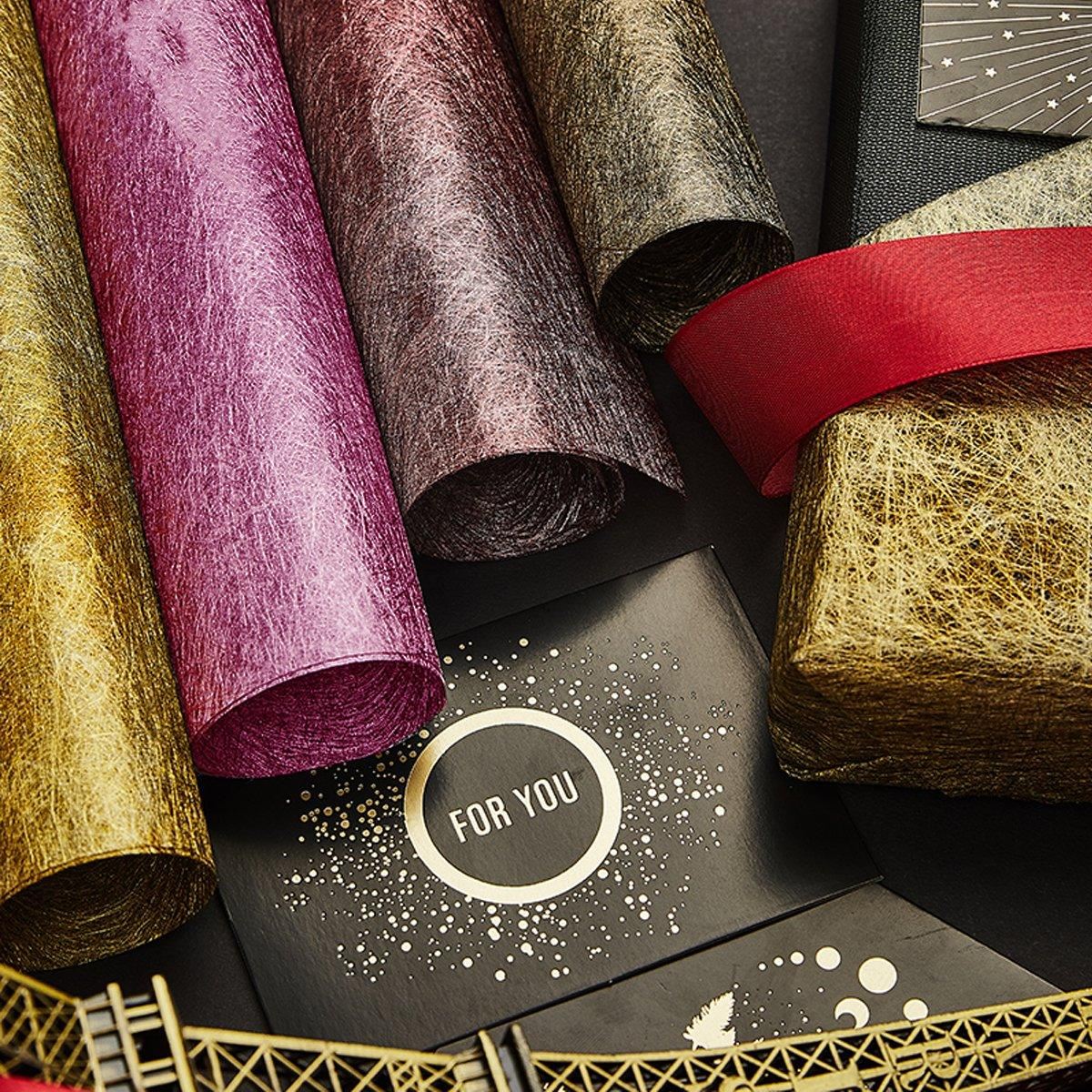 A selection of fabric sheets in various colors, including pink, white, brown, and blue.