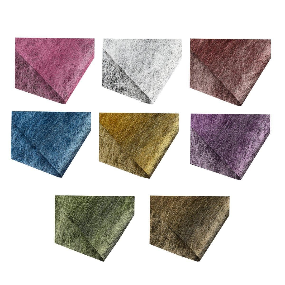 A selection of fabric sheets in various colors, including pink, white, brown, and blue.