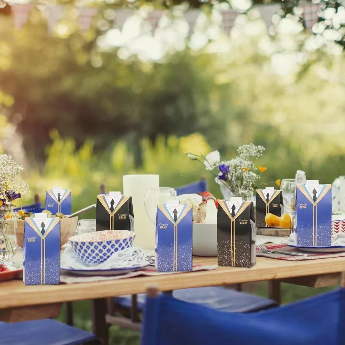 A row of graduation-themed candy boxes arranged neatly on a table, ready for a celebration.
