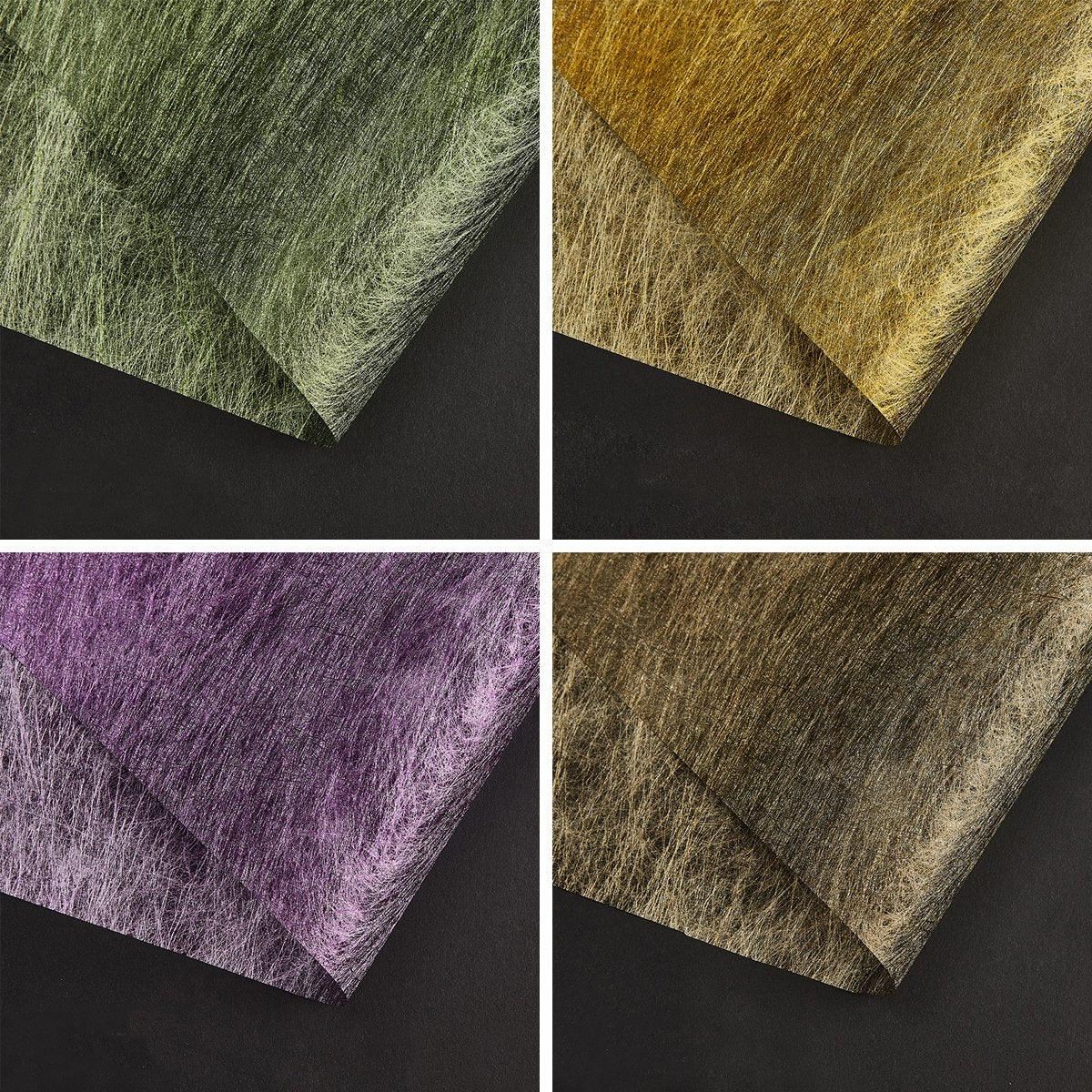 A selection of fabric sheets in various colors, including pink, white, brown, and blue.