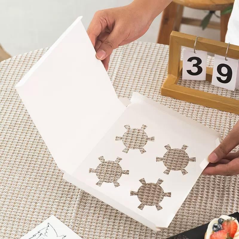 Clear cupcake box showcasing beautifully decorated cupcakes.