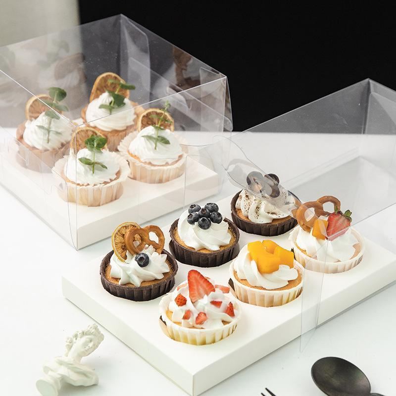 Clear cupcake box showcasing beautifully decorated cupcakes.