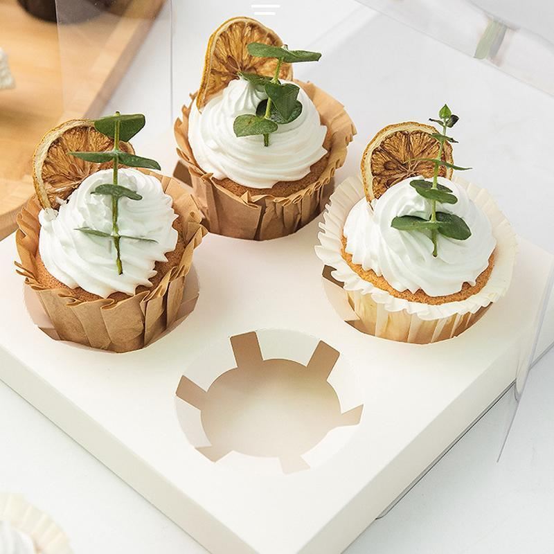Clear cupcake box showcasing beautifully decorated cupcakes.