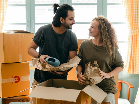 A couple is unpacking boxes