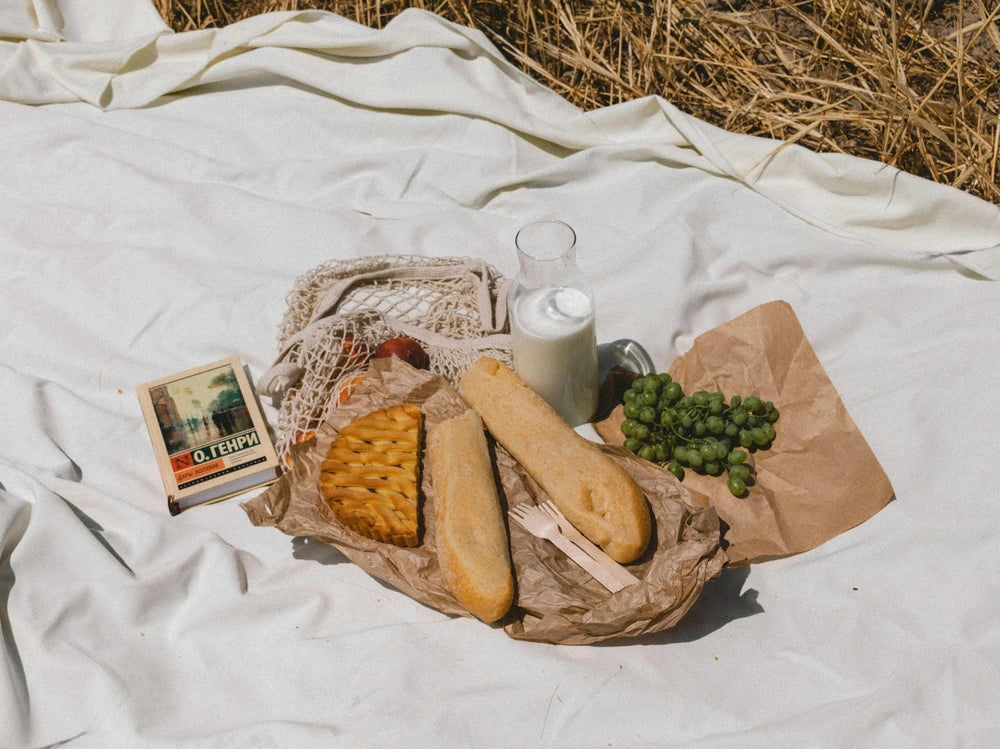 a rustic picnic setup with bread wrapped in paper