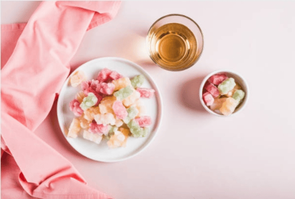 A plate and a small bowl filled with colorful, bite-sized candies