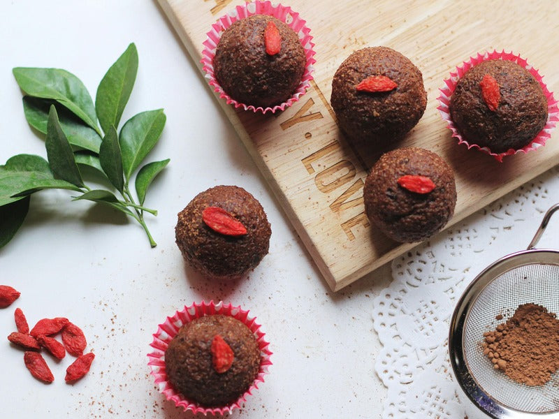 Five chocolate cupcakes topped with goji berries