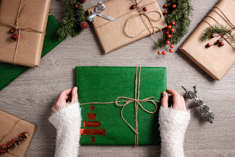 a Christmas gift wrapped in green paper with twine