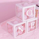 Clear balloon boxes filled with colorful balloons for party decor