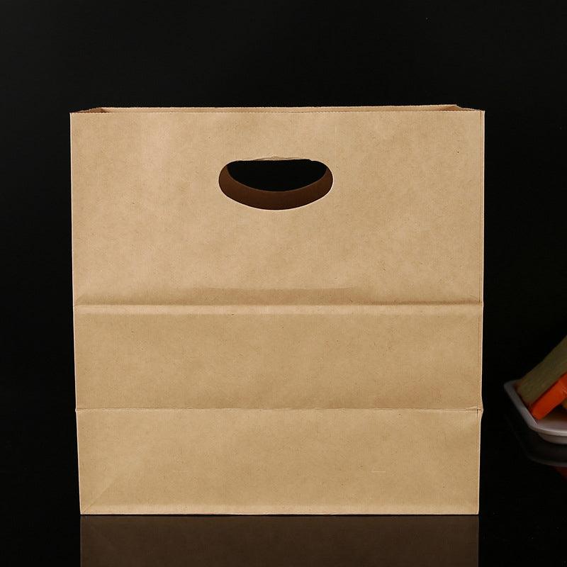 Paper grocery bags filled with fresh produce