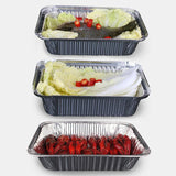 A selection of food items served on high-quality aluminium foil plates, showcasing their durability and versatility.