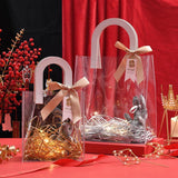 Set of elegant transparent goodie bags with sturdy handles