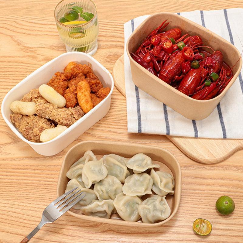 An assortment of food served in high-quality disposable bowls at a festive gathering.