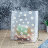 A stack of beautifully wrapped presents with colorful plastic bags with handles