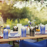 A row of graduation-themed candy boxes arranged neatly on a table, ready for a celebration.
