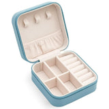 Compact and elegant travel jewelry case with multiple compartments