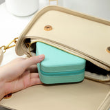 Compact and elegant travel jewelry case with multiple compartments