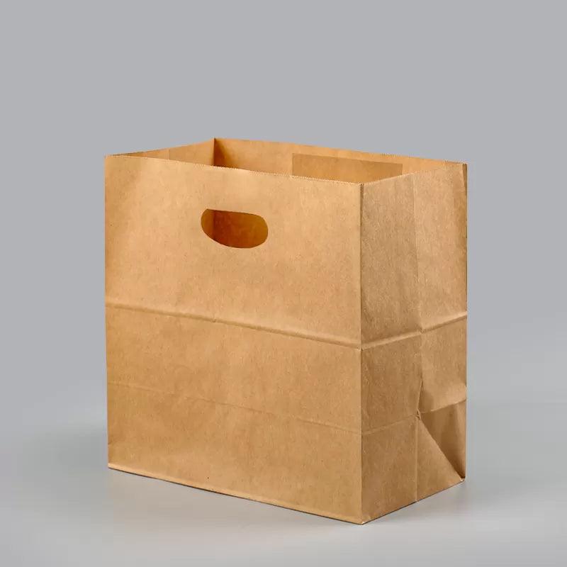 Paper grocery bags filled with fresh produce