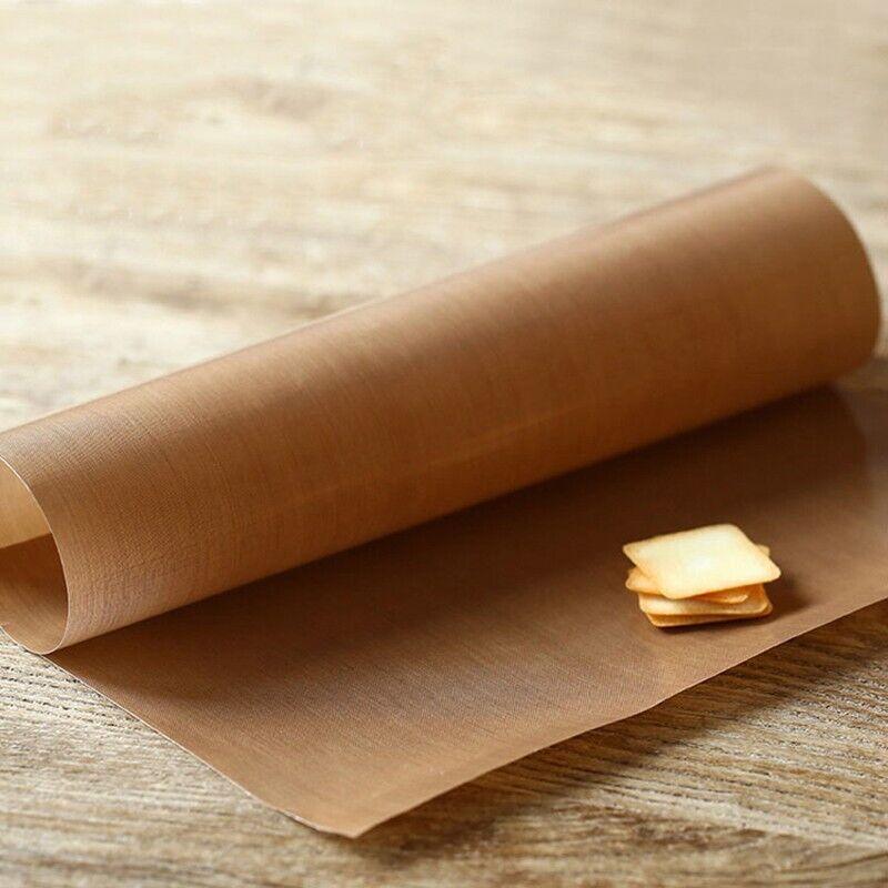 Reusable baking mat placed on a baking sheet with freshly baked cookies