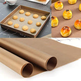 Reusable baking mat placed on a baking sheet with freshly baked cookies