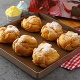 Reusable baking mat placed on a baking sheet with freshly baked cookies