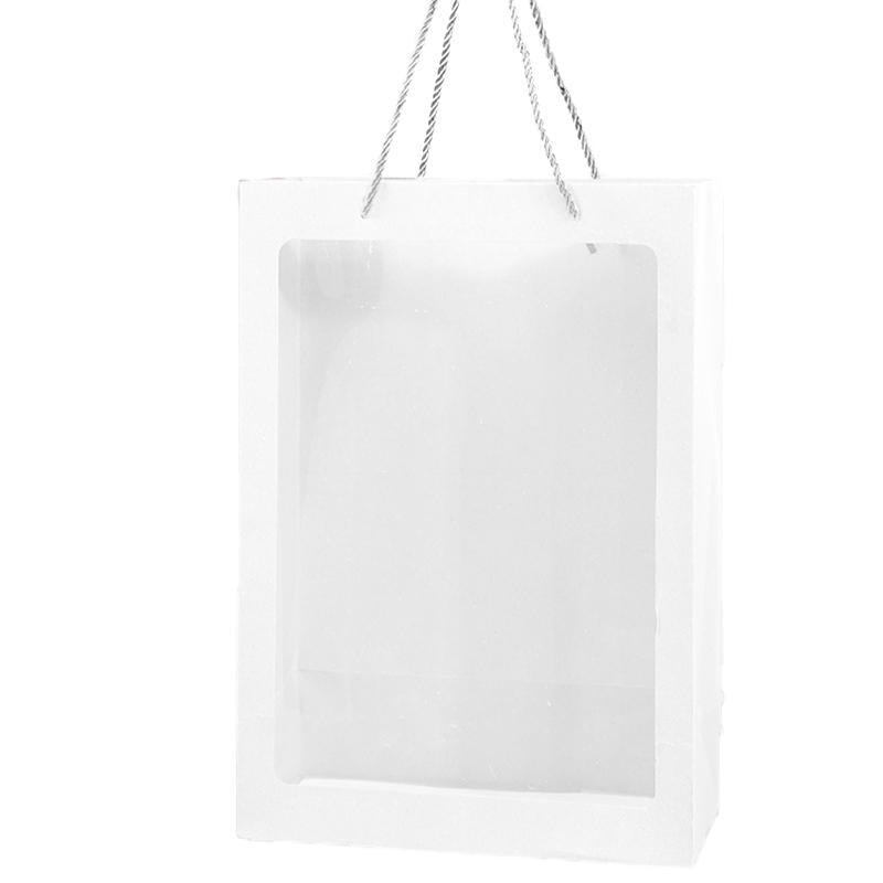 Elegant White Paper Bags lined up on a store counter, ready for customer purchases.