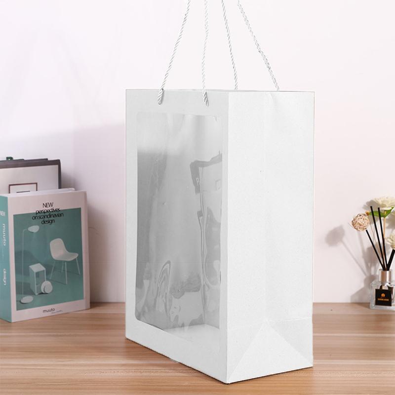 Elegant White Paper Bags lined up on a store counter, ready for customer purchases.