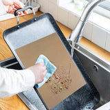 Reusable baking mat placed on a baking sheet with freshly baked cookies