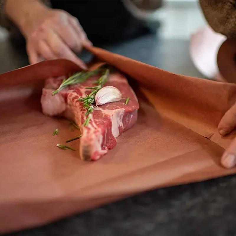 Butcher paper roll being dispensed in a kitchen setting