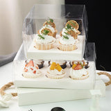 Clear cupcake box showcasing beautifully decorated cupcakes.