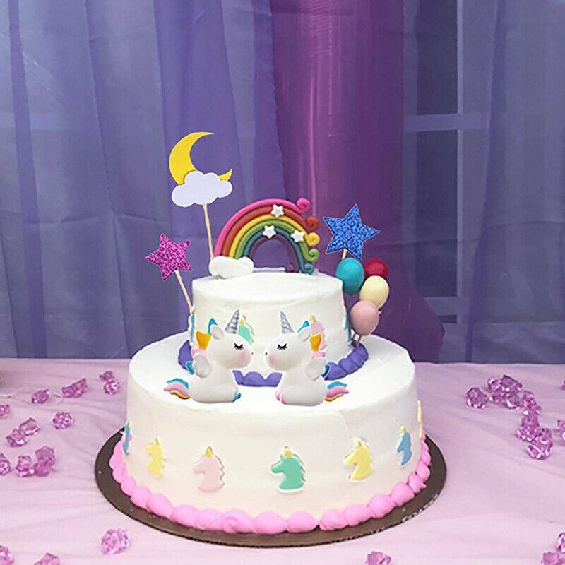 Whimsical unicorn cake topper with rainbow mane and golden horn